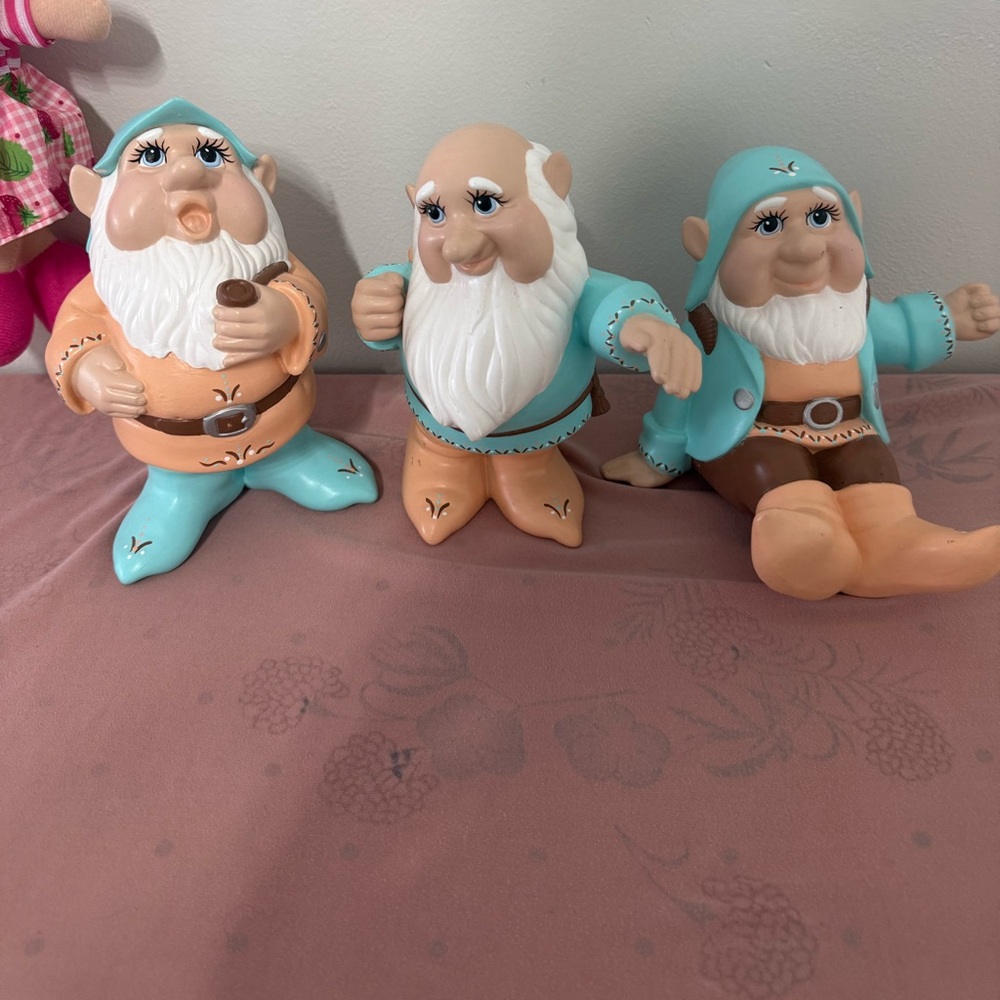 three hand-painted ceramic figurines of dwarfs,
